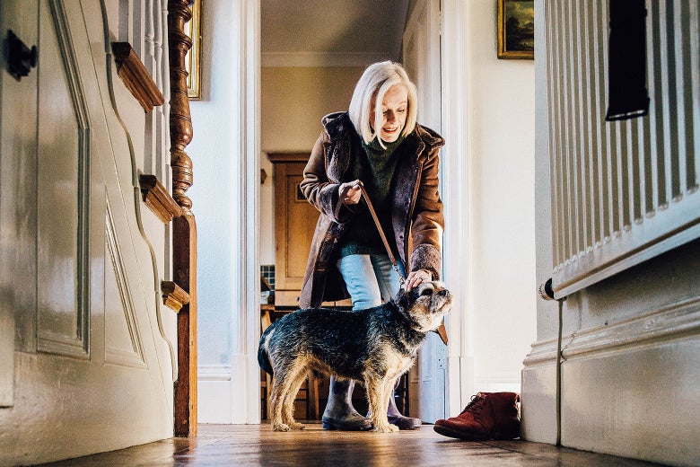 Senior with her cat in her house.